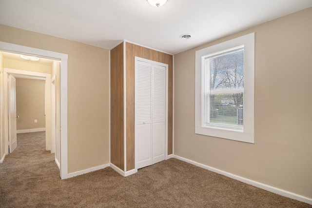 2335 Holmes Rd, Ypsilanti, MI 48198 - unfurnished bedroom with carpet, a closet, and baseboards