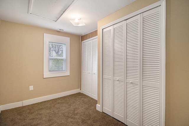 2335 Holmes Rd, Ypsilanti, MI 48198 - unfurnished bedroom featuring dark carpet, baseboards, and a closet