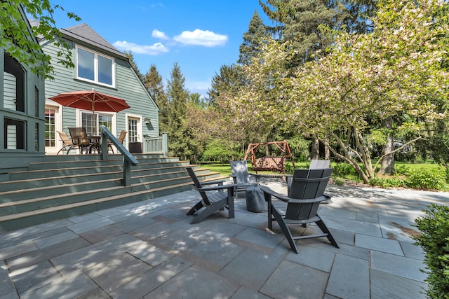 2462 N Dixboro Rd, Ann Arbor, MI 48105 - view of patio with an outdoor fire pit, a deck, and outdoor dining space
