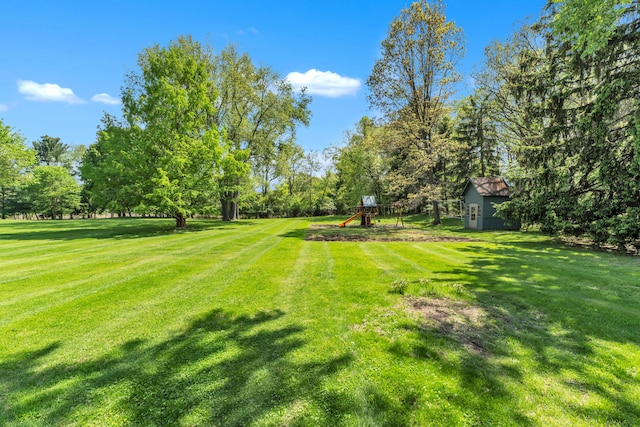 2462 N Dixboro Rd, Ann Arbor, MI 48105 - view of green lawn with a playground and view of scattered trees