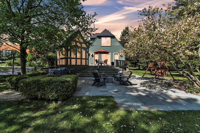 2462 N Dixboro Rd, Ann Arbor, MI 48105 - back of property with a patio, a playground, and a yard