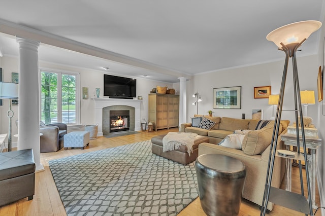 2462 N Dixboro Rd, Ann Arbor, MI 48105 - living room with ornate columns, ornamental molding, light wood-style floors, and a fireplace