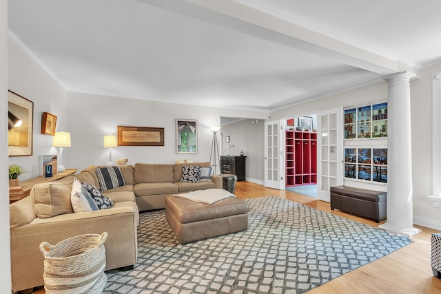 2462 N Dixboro Rd, Ann Arbor, MI 48105 - living area featuring crown molding, decorative columns, wood finished floors, and baseboards