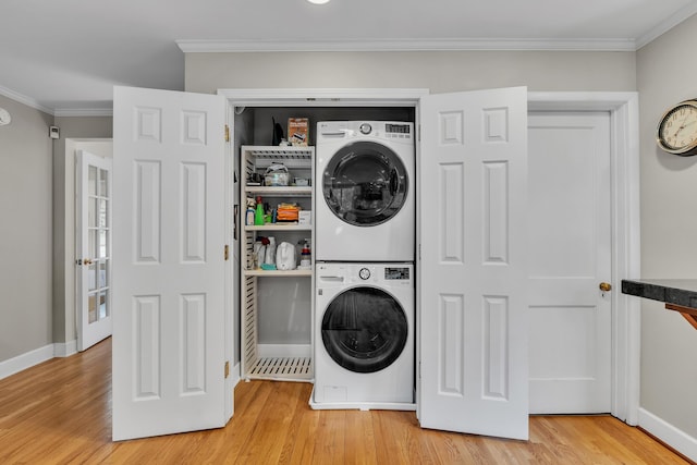 2462 N Dixboro Rd, Ann Arbor, MI 48105 - laundry room with estacked washer and dryer, light wood-type flooring, crown molding, and baseboards