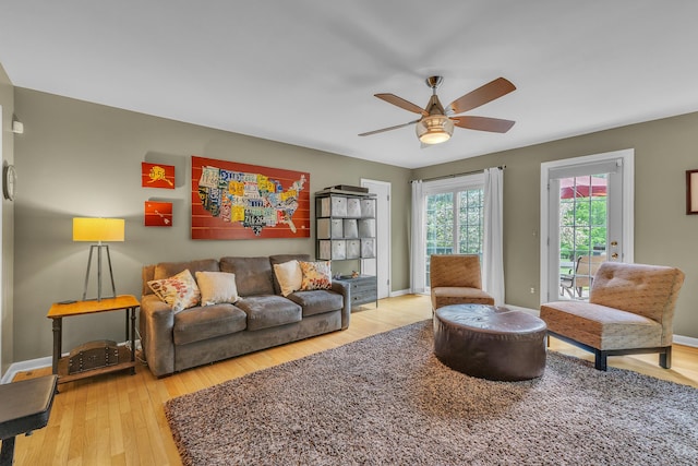 2462 N Dixboro Rd, Ann Arbor, MI 48105 - living area featuring a ceiling fan, light wood-style flooring, and baseboards