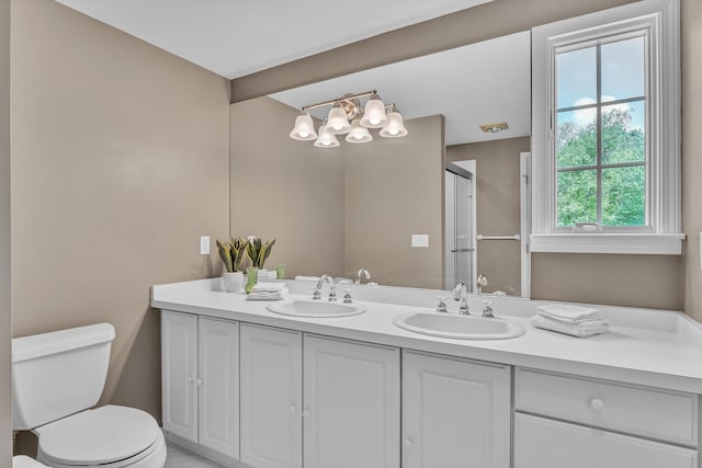 2462 N Dixboro Rd, Ann Arbor, MI 48105 - bathroom with toilet, a chandelier, double vanity, and a shower with shower door
