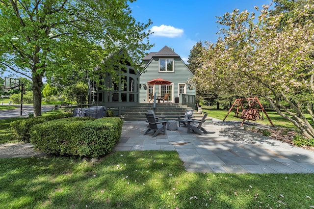 2462 N Dixboro Rd, Ann Arbor, MI 48105 - rear view of property featuring a patio area, a playground, a yard, and a wooden deck
