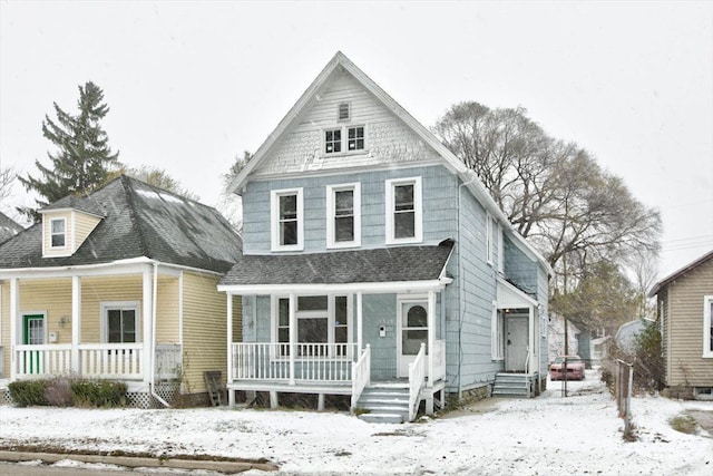 view of front facade with covered porch and roof with shingles
