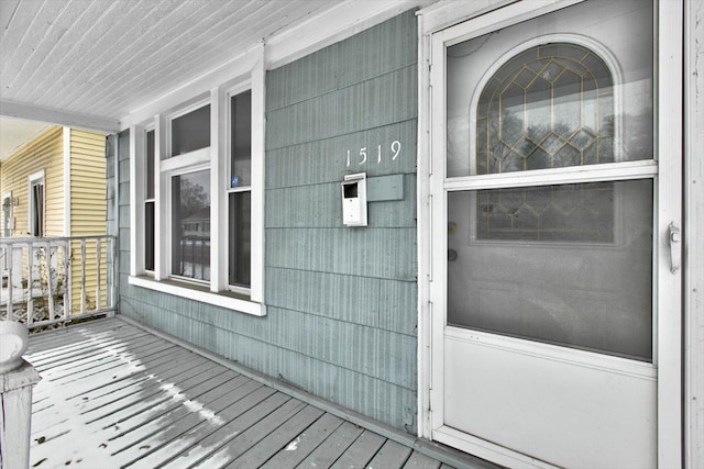 view of exterior entry with a porch