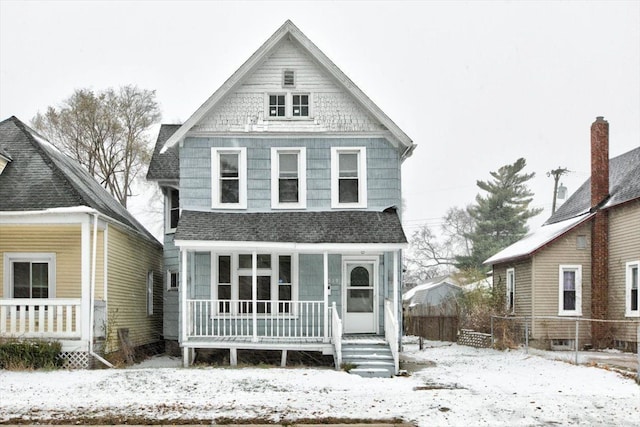 view of front of home featuring a porch, roof with shingles, and fence