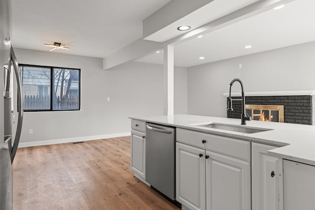 29244 Marshall St, Southfield, MI 48076 - kitchen with appliances with stainless steel finishes, a sink, light wood-style flooring, white cabinetry, and light countertops
