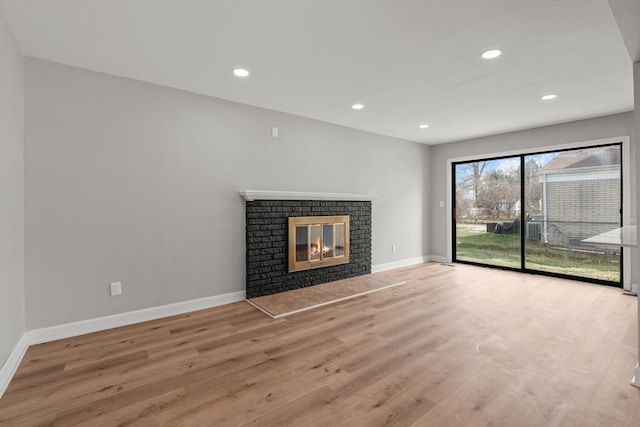 29244 Marshall St, Southfield, MI 48076 - unfurnished living room with wood finished floors, baseboards, a fireplace, and recessed lighting