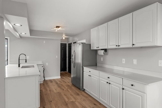 29244 Marshall St, Southfield, MI 48076 - kitchen with a sink, stainless steel refrigerator with ice dispenser, white cabinets, light wood-style flooring, and recessed lighting