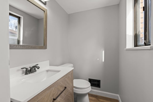 29244 Marshall St, Southfield, MI 48076 - half bathroom with wood finished floors, toilet, baseboards, and vanity