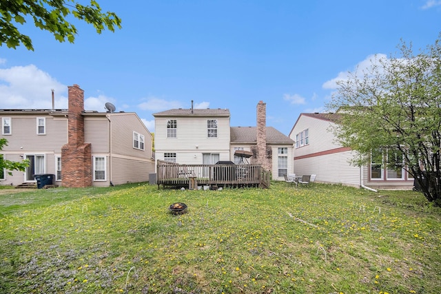 3049 Turnberry Ln, Ann Arbor, MI 48108 - rear view of property featuring a lawn, a deck, an outdoor fire pit, and a chimney