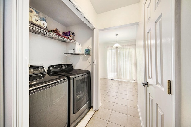 3049 Turnberry Ln, Ann Arbor, MI 48108 - laundry area featuring light tile patterned floors and washer and clothes dryer