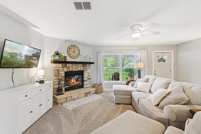 75349 12th Ave, South Haven, MI 49090 - living room with light colored carpet, ceiling fan, and a stone fireplace