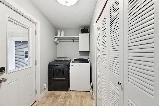 75349 12th Ave, South Haven, MI 49090 - laundry area with cabinet space, independent washer and dryer, light wood finished floors, and baseboards