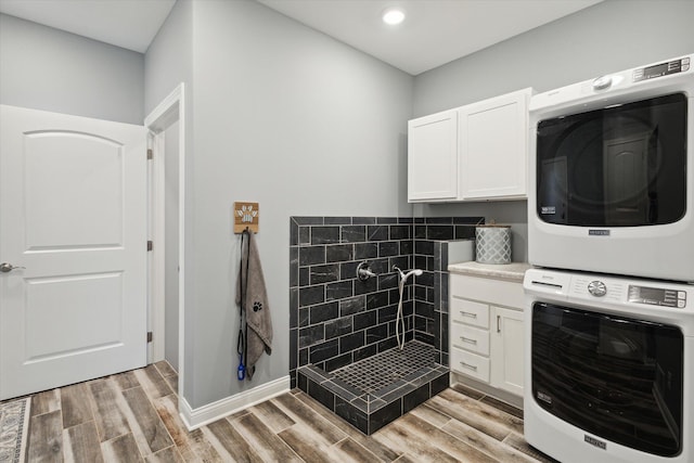 292 Lyon Lake Rd, Marshall, MI 49068 - laundry room featuring stacked washer / drying machine, cabinet space, light wood-style floors, recessed lighting, and baseboards