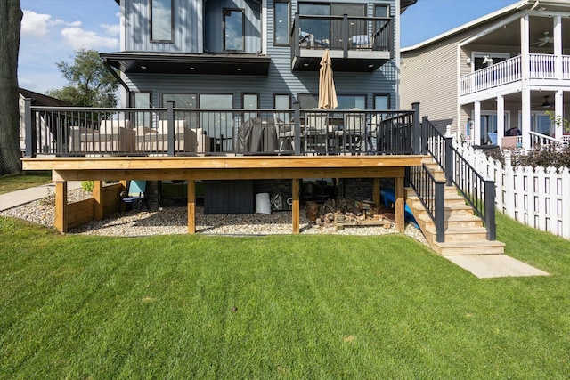 292 Lyon Lake Rd, Marshall, MI 49068 - back of property featuring a lawn, ceiling fan, stairway, and a deck