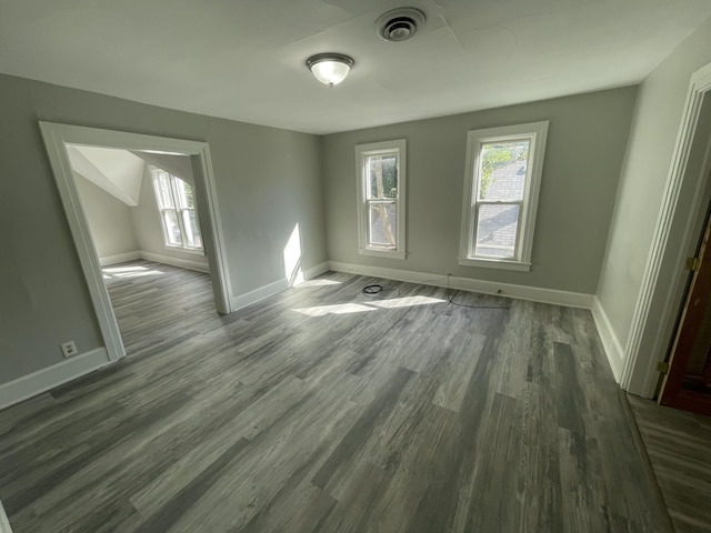 811 Park St SW, Grand Rapids, MI 49504 - empty room featuring plenty of natural light, dark wood-style floors, and baseboards