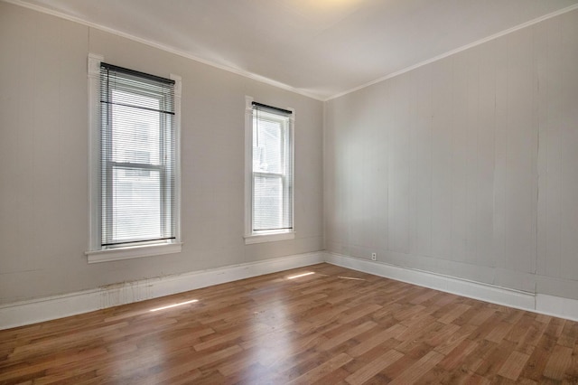 811 Park St SW, Grand Rapids, MI 49504 - empty room with wood finished floors, healthy amount of natural light, crown molding, and baseboards