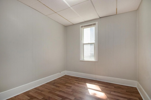811 Park St SW, Grand Rapids, MI 49504 - unfurnished room featuring dark wood-style floors, a drop ceiling, and baseboards