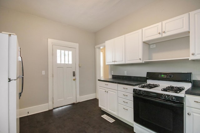 811 Park St SW, Grand Rapids, MI 49504 - kitchen featuring range with gas cooktop, freestanding refrigerator, baseboards, and dark countertops