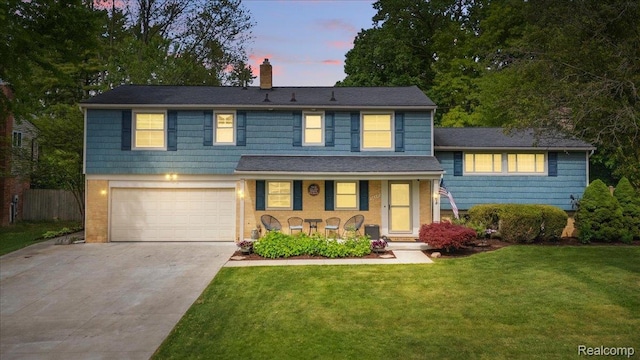 26347 Greythorne Trl, Farmington Hills, MI 48334 - view of front facade with an attached garage, covered porch, a chimney, and driveway