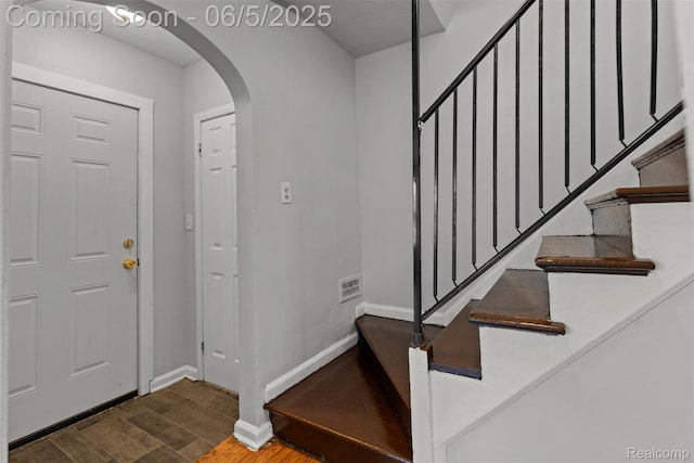 15285 Hazelridge St, Detroit, MI 48205 - foyer featuring arched walkways, wood finished floors, stairs, and baseboards