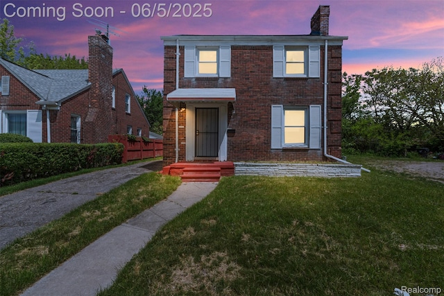15285 Hazelridge St, Detroit, MI 48205 - traditional-style house featuring a front yard, brick siding, and a chimney