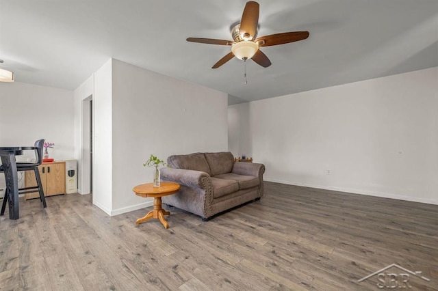 2119 Bayliss St, Midland, MI 48640 - living room featuring a ceiling fan, wood finished floors, and baseboards
