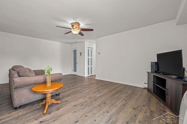 2119 Bayliss St, Midland, MI 48640 - living room with a ceiling fan, wood finished floors, baseboards, and baseboard heating
