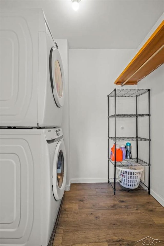 2119 Bayliss St, Midland, MI 48640 - clothes washing area featuring stacked washer / dryer, baseboards, and wood finished floors