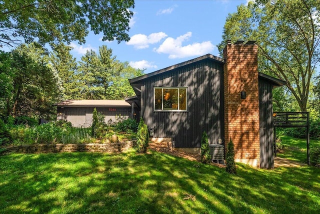 7044 Cascade Rd SE, Grand Rapids, MI 49546 - view of side of home with a chimney and a yard