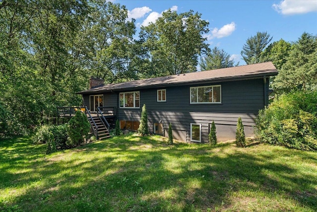 7044 Cascade Rd SE, Grand Rapids, MI 49546 - rear view of house with stairway, a wooden deck, a chimney, and a lawn