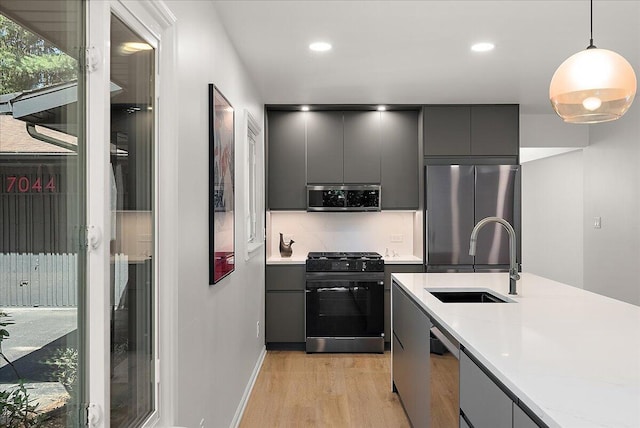 7044 Cascade Rd SE, Grand Rapids, MI 49546 - kitchen with appliances with stainless steel finishes, gray cabinets, light wood-type flooring, modern cabinets, and light countertops