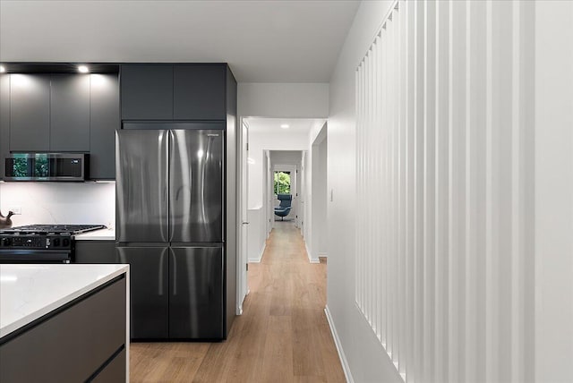 7044 Cascade Rd SE, Grand Rapids, MI 49546 - kitchen featuring stainless steel appliances, gray cabinetry, light wood-style flooring, modern cabinets, and light stone counters