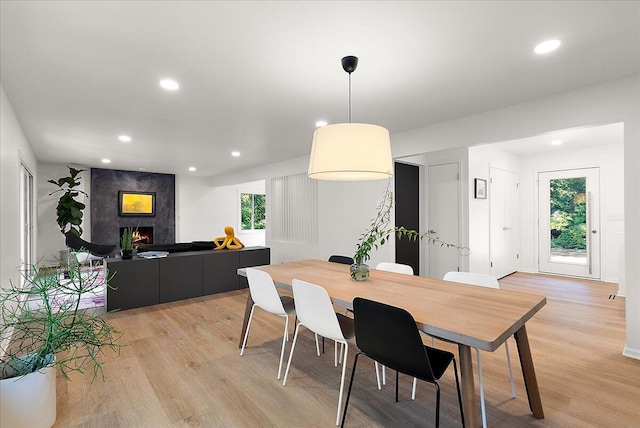 7044 Cascade Rd SE, Grand Rapids, MI 49546 - dining space featuring a high end fireplace, light wood-style floors, and recessed lighting