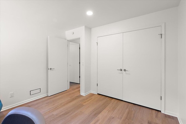 7044 Cascade Rd SE, Grand Rapids, MI 49546 - unfurnished bedroom with light wood finished floors, a closet, and recessed lighting