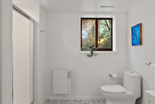 7044 Cascade Rd SE, Grand Rapids, MI 49546 - bathroom featuring radiator heating unit and a shower stall