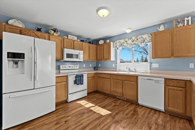9009 N Pheasant Ridge Ln, Saline, MI 48176 - kitchen featuring white appliances, a sink, wood finished floors, and light countertops