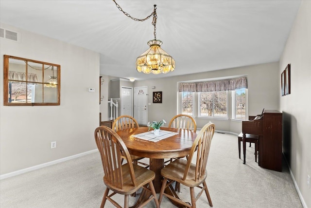 9009 N Pheasant Ridge Ln, Saline, MI 48176 - dining area featuring light colored carpet, a chandelier, and baseboards