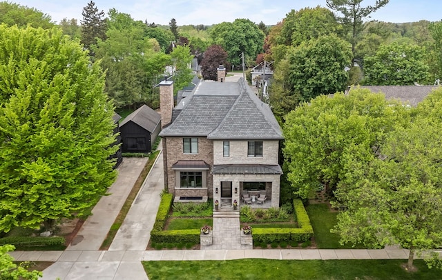 628 Watkins St, Birmingham, MI 48009 - view of front facade with a standing seam roof, a chimney, a front yard, metal roof, and a shingled roof
