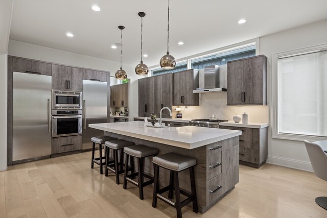 628 Watkins St, Birmingham, MI 48009 - kitchen with built in appliances, a sink, wall chimney exhaust hood, a kitchen breakfast bar, and modern cabinets