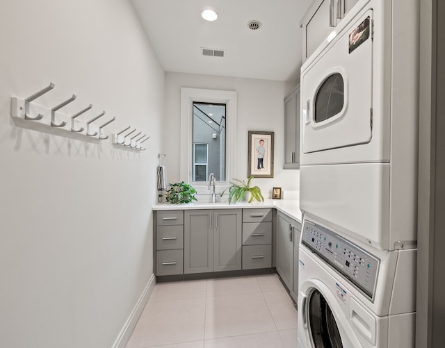 628 Watkins St, Birmingham, MI 48009 - washroom with stacked washer / dryer, cabinet space, light tile patterned floors, baseboards, and recessed lighting