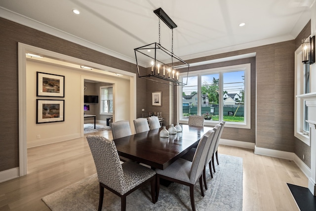 628 Watkins St, Birmingham, MI 48009 - dining area with a chandelier, baseboards, plenty of natural light, crown molding, and light wood-style flooring