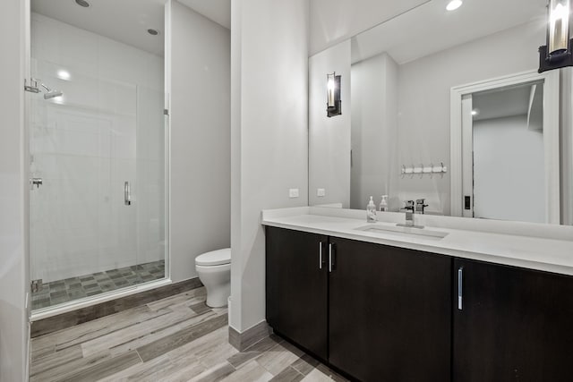 628 Watkins St, Birmingham, MI 48009 - full bathroom with toilet, a stall shower, vanity, wood finished floors, and recessed lighting