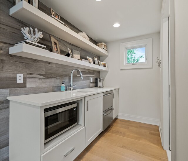 628 Watkins St, Birmingham, MI 48009 - kitchen featuring open shelves, appliances with stainless steel finishes, a sink, light wood-type flooring, and baseboards