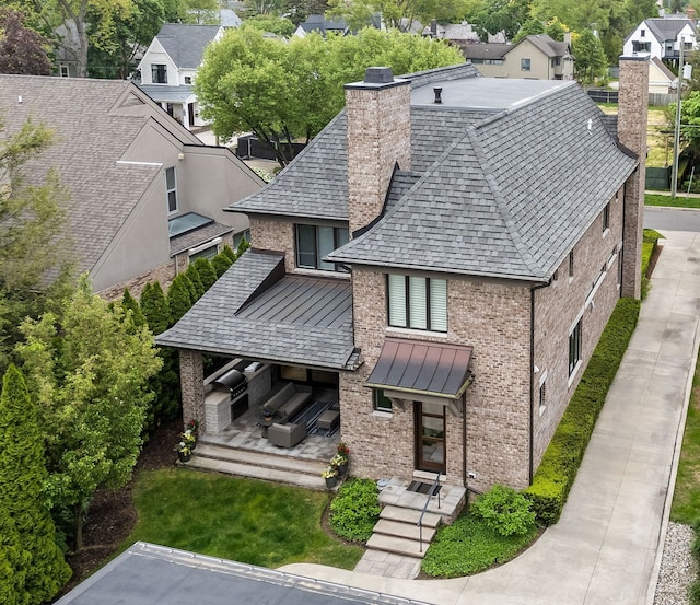 628 Watkins St, Birmingham, MI 48009 - rear view of house with brick siding, a chimney, a standing seam roof, a residential view, and a shingled roof